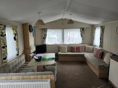 a living room with a couch and a table at Chapmans Holiday Home Newquay in Newquay