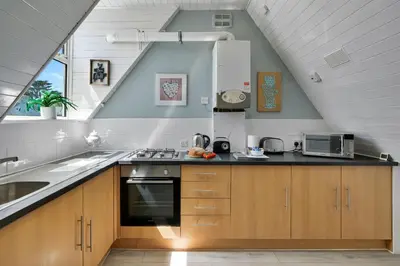 a kitchen with a sink and a stove top oven at Finest Retreats - No 11 Porthminster in St Ives
