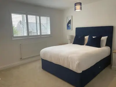 a bedroom with a large bed and a window at 30 Bredon Court at Fistral Beach Newquay in Newquay