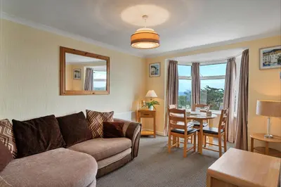 a living room with a couch and a table at Finest Retreats - Number 10 Porthmeor in St Ives