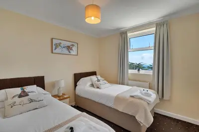 a bedroom with two beds and a window at Finest Retreats - Number 10 Porthmeor in St Ives
