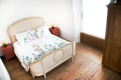 a bedroom with a bed with flowers on it at Wellington House Boutique Holiday Let in Falmouth