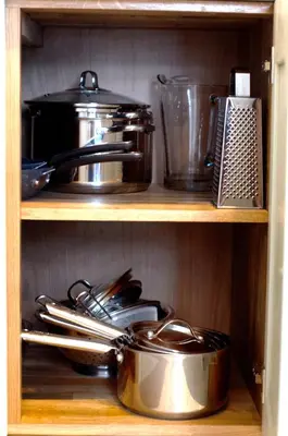 a shelf with pots and pans and other kitchen items at Wellington House Boutique Holiday Let in Falmouth