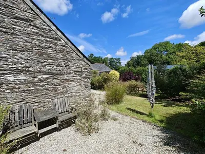 a bench sitting in front of a stone building at 3 Bed in St. Ervan oc-t29660 in Little Petherick