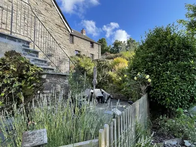a garden with a fountain in front of a house at 3 Bed in St. Ervan oc-t29660 in Little Petherick