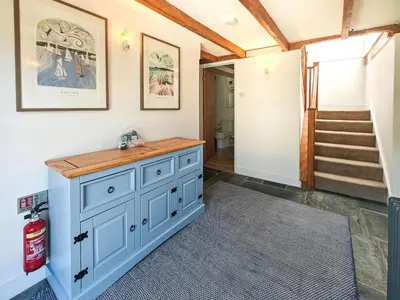 a room with a blue cabinet and a staircase at 3 Bed in St. Ervan oc-t29660 in Little Petherick