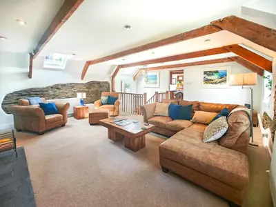 a large living room with couches and a table at 3 Bed in St. Ervan oc-t29660 in Little Petherick