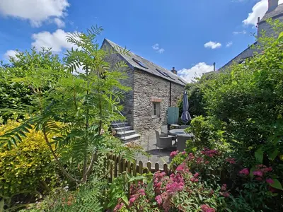 an old stone cottage with a garden and flowers at 3 Bed in St. Ervan oc-t29660 in Little Petherick