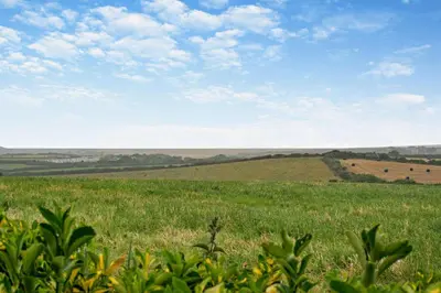 a field of green grass with a blue sky and clouds at 2 Bed in St. Merryn oc-w29716 in St Merryn