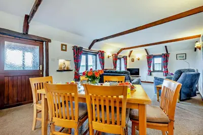 a dining room and living room with a table and chairs at 2 Bed in St. Merryn oc-w29716 in St Merryn
