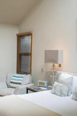 a bedroom with a bed and a couch and a chair at Prospect House in Padstow