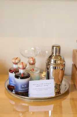 a tray with bottles of perfume on a table at Prospect House in Padstow