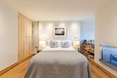 a bedroom with a large bed and a tv at Prospect House in Padstow