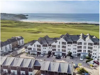 an aerial view of a resort with the ocean at Newquay Beach House by Signature Stays - Parking - Modern - Coastal in Newquay