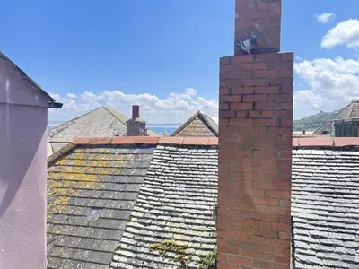 a rooftop of a building with a brick chimney at Mermaids Rest in St Ives