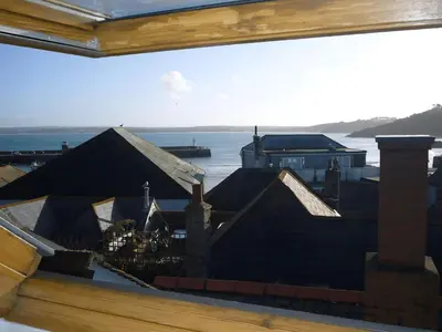 a painting of a house with a view of the water at Mermaids Rest in St Ives