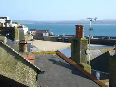 a view of the roofs of houses and the ocean at Mermaids Rest in St Ives