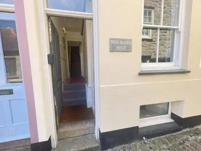an entrance to a house with a sign on the door at Mermaids Rest in St Ives