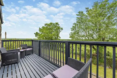 a deck with wicker chairs and a table and chairs at 2 Bed in St. Minver oc-r29475 in Saint Minver