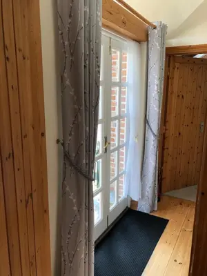 a room with a door and a window at The Nook in Padstow