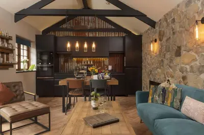 a living room with a stone wall at The Old Dairy in Camborne