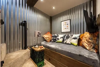 a room with a couch with pillows on it at The Old Dairy in Camborne
