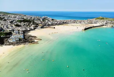 an aerial view of a beach with people in the water at The Old Dairy in Camborne