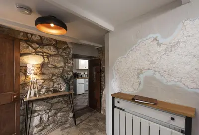 a room with a map on the wall at The Corner Cottage in Camborne