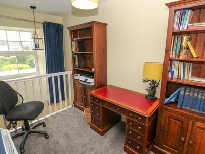 an office with a desk and a book shelf at The Old Post Office in Camborne