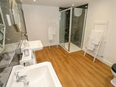 a bathroom with two sinks and a shower at The Old Post Office in Camborne