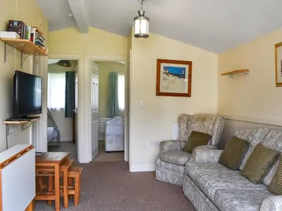 a living room with a couch and a tv at Cat's Cove - Uk47720 in St Merryn