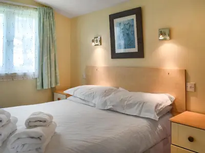 a bedroom with a bed with towels on it at Cat's Cove - Uk47720 in St Merryn