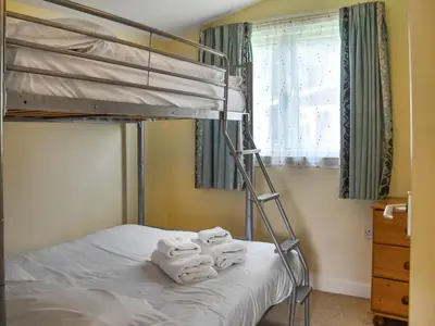 a bedroom with a bunk bed with towels on it at Cat's Cove - Uk47720 in St Merryn