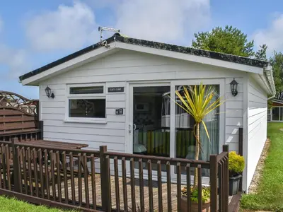 a small white shed with a wooden fence at Cat's Cove - Uk47720 in St Merryn