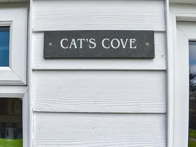 a garage door with a sign that reads cats cove at Cat's Cove - Uk47720 in St Merryn