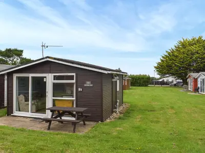 a shed with a picnic table in a yard at Old Town Cove - Uk47724 in St Merryn