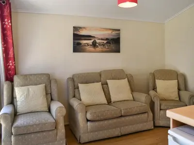 a living room with two chairs and a couch at Harbour Cove - Uk47722 in St Merryn