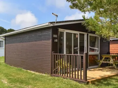 a tiny house with a porch and a deck at Harbour Cove - Uk47722 in St Merryn