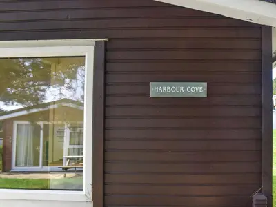 a sign on the side of a house with a window at Harbour Cove - Uk47722 in St Merryn