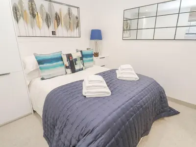 a bedroom with a bed with two towels on it at 2A Salubrious Terrace in St Ives
