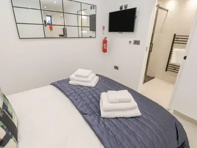 a bedroom with a bed with towels on it at 2A Salubrious Terrace in St Ives