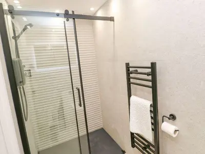 a shower with a glass door in a bathroom at 2A Salubrious Terrace in St Ives