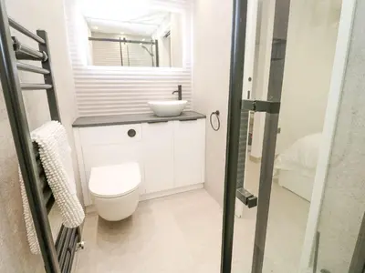 a bathroom with a toilet and a sink at 2A Salubrious Terrace in St Ives