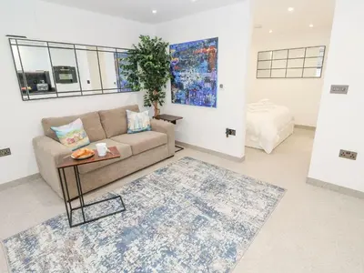 a living room with a couch and a table at 2A Salubrious Terrace in St Ives
