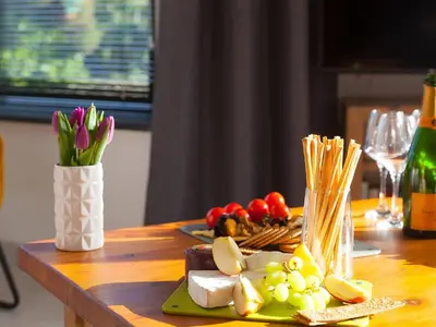 a table with a plate of cheese and fruit and vegetables at Nova Cottage in St Ives