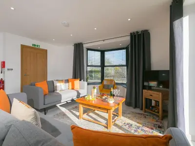 a living room with a couch and a table at Nova Cottage in St Ives
