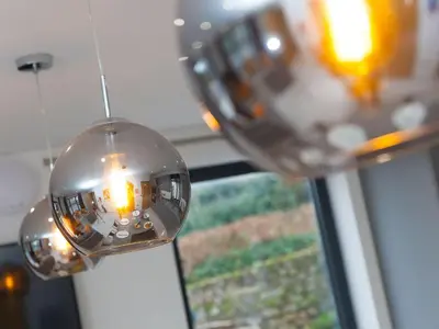 a pair of wine glasses hanging in front of a window at Nova Cottage in St Ives