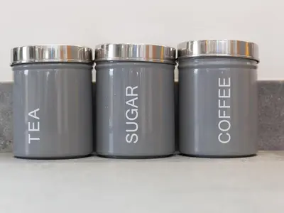 four grey trash cans sitting on a shelf at Nova Cottage in St Ives