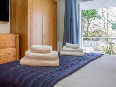 a pile of towels sitting on top of a bed at Sea Bleu in St Ives