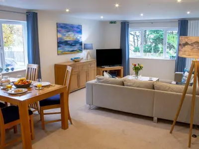 a living room with a couch and a table at Sea Bleu in St Ives